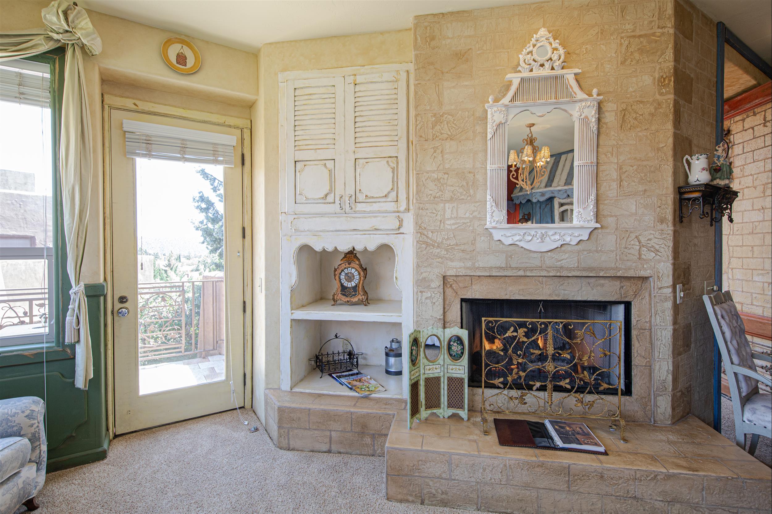 a picture of fireplace and a mirror on the wall