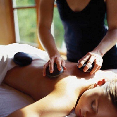 woman receiving hot stone massage