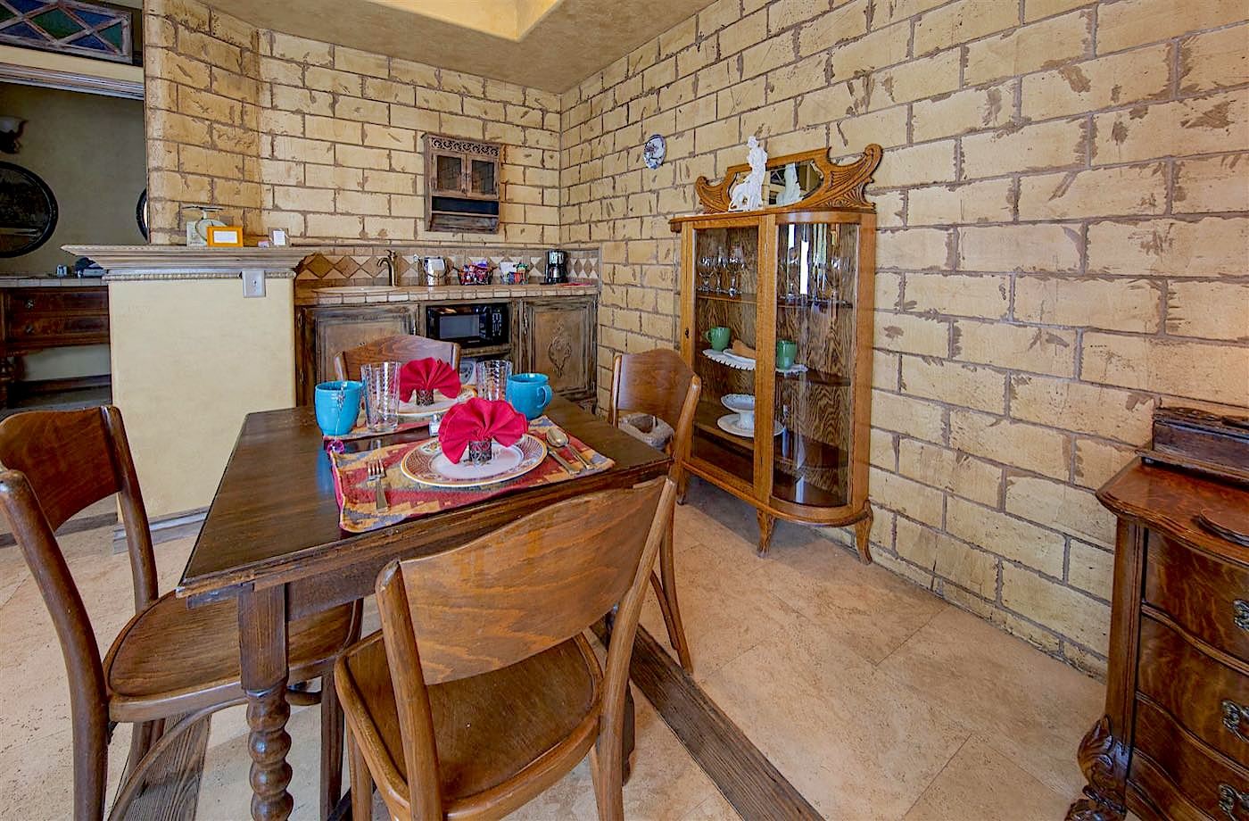 Antiquities villa kitchenette and dining table against stone walls