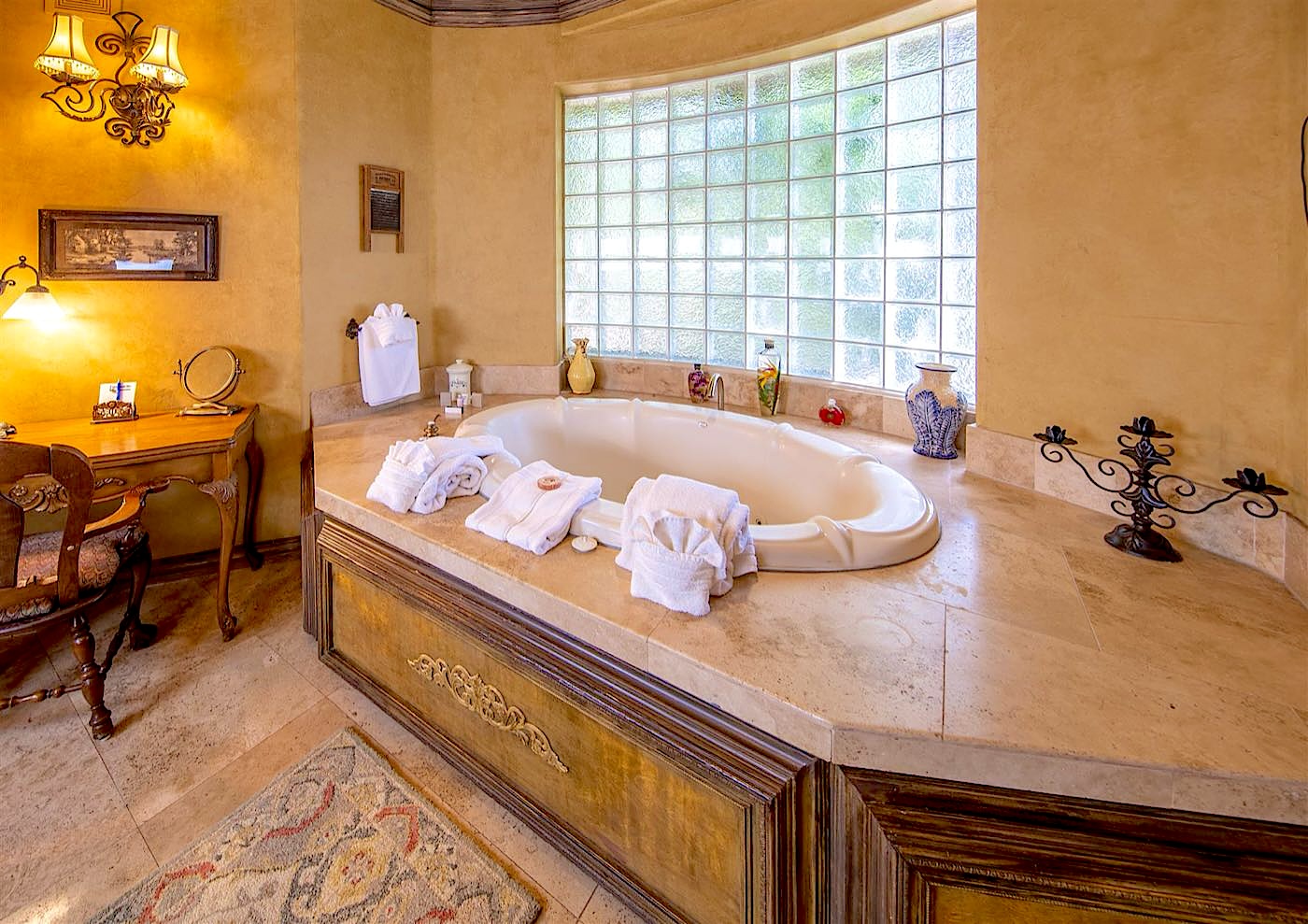 Antiquities villa jetted tub beneath a glass-block window