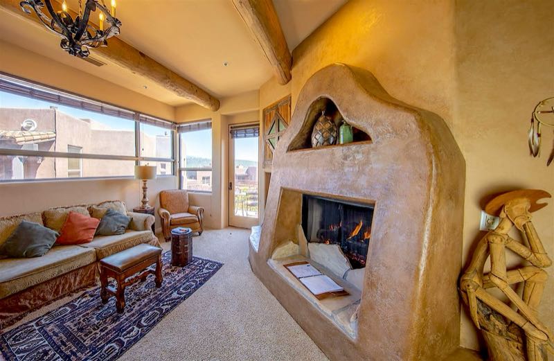 Cactus Flower villa sitting area with a sculpted adobe fireplace