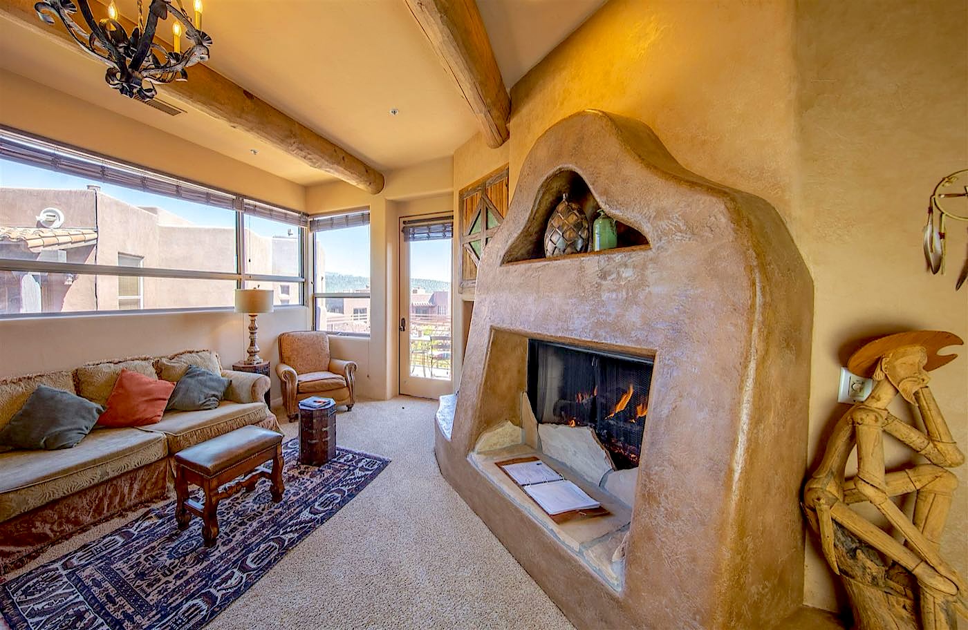 Cactus Flower villa sitting area with a sculpted adobe fireplace