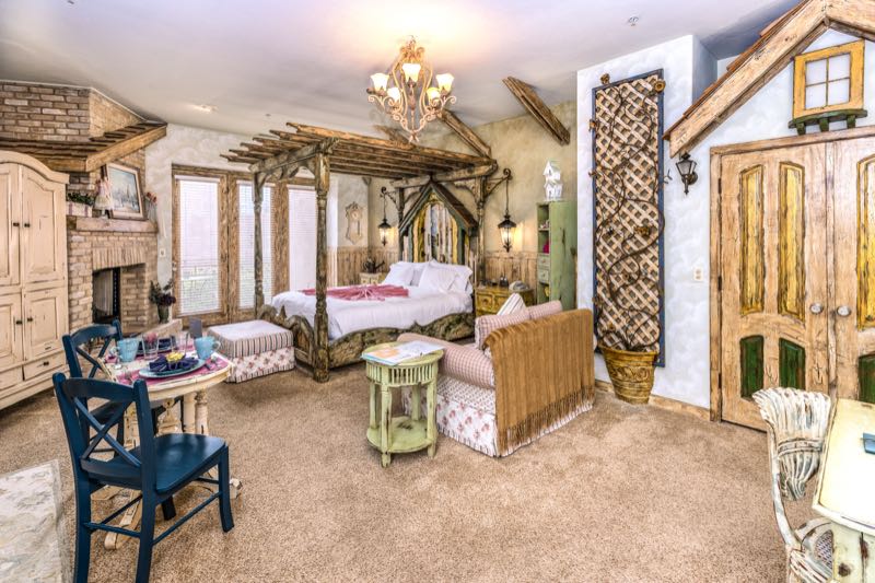 Country Garden villa bedroom with a dining table and fireplace