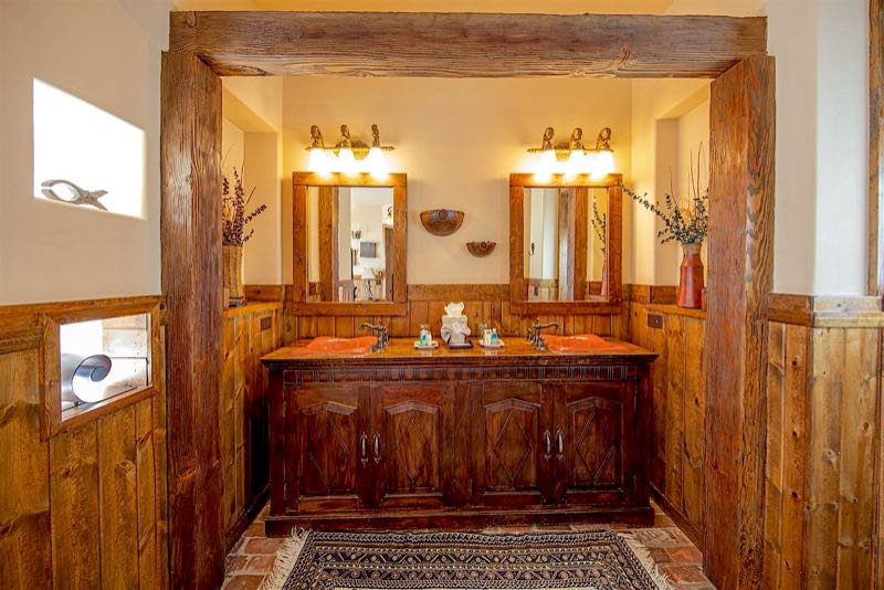 Red Cinder villa double vanity framed in dark wood