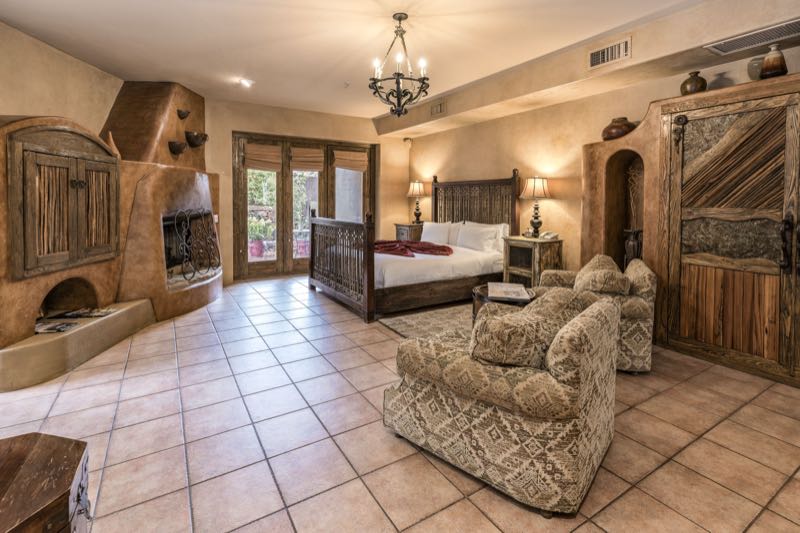 Sedona Breeze villa bedroom and sitting area with a kiva fireplace