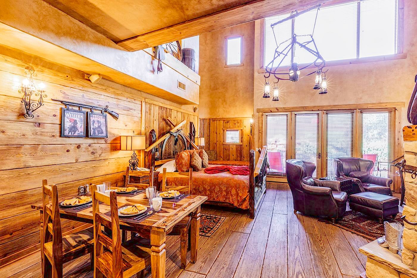 Silver Spur villa two-level living and dining room with a loft and wagon-wheel chandelier at Adobe Grand Villas in Sedona