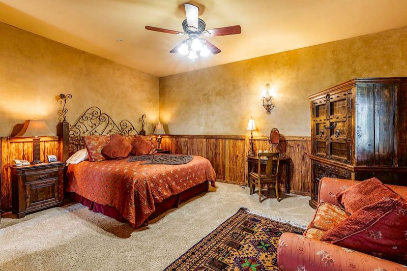 Silver Spur villa bedroom with a carved headboard