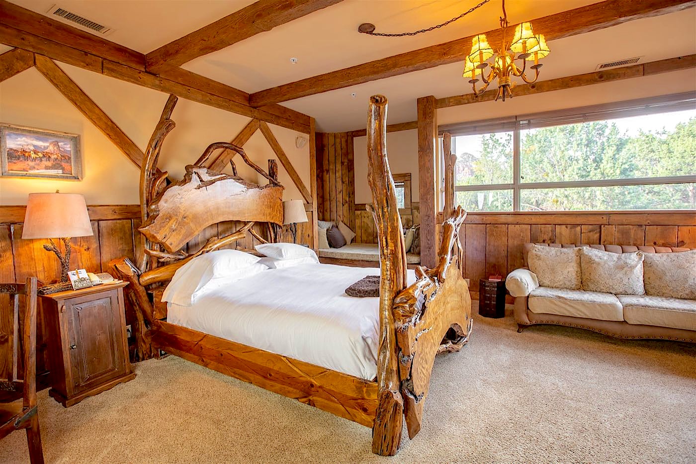 Timbers villa log bed beneath timber beams at Adobe Grand Villas in Sedona