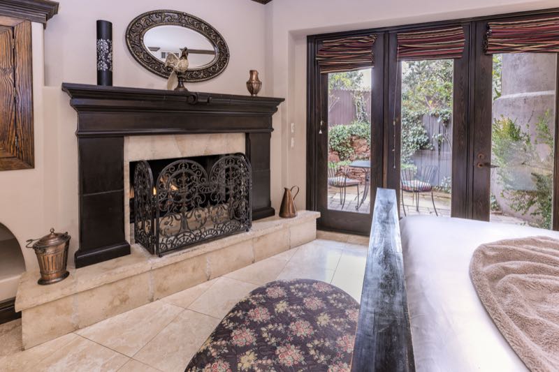 Tuscany villa fireplace and doors to the patio