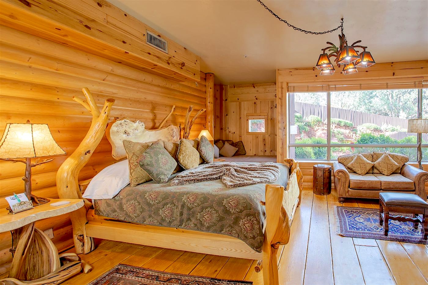 Whispering Pine villa log bed and light-pine walls at Adobe Grand Villas in Sedona