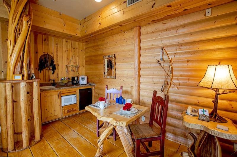 Whispering Pine villa kitchenette with a log table