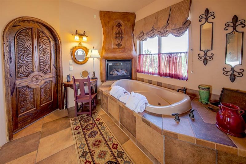 White Dove villa jetted tub beside an arched wooden door